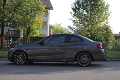 BMW M235i xDrive Coupé — Performance M avec extras carbone et 4 places — side view