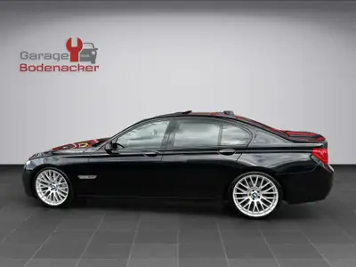 BMW 740d M Sport — Berline prestige diesel, entretien récent, 21 pouces — rear view