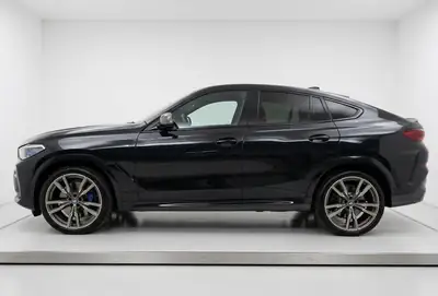 BMW X6 M50d — SUV coupé musclé, 400 ch diesel, équipement complet — côté